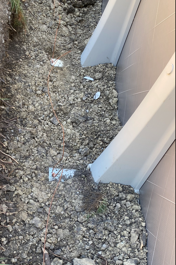 #8 copper bonding conductor installed along pool perimeter wall, showing direct burial next to pool frame—per NEC 680.26 requirements