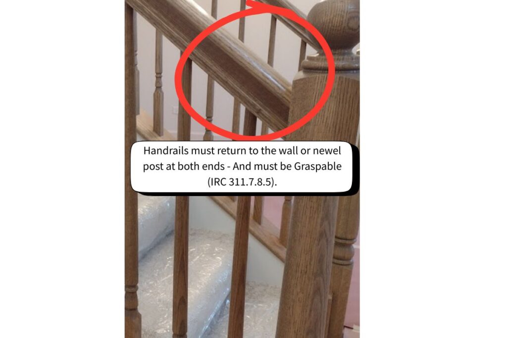 Residential stair handrail meeting IRC 311.7.8.5 requirements for graspable size and handrail return to wall or newel post.