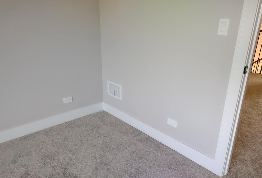 Example of general wall receptacle spacing in a living area, showing two electrical outlets installed per NEC 210.52(A) requirements.