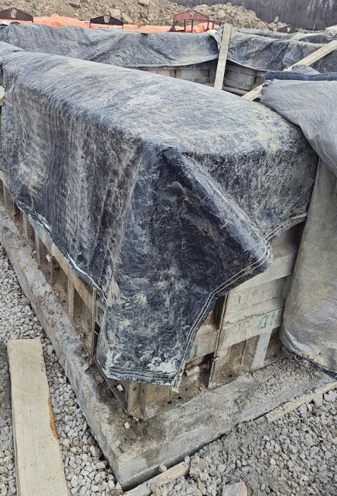 Foundation walls protected with insulated blankets for cold weather curing in Zone 5 jobsite