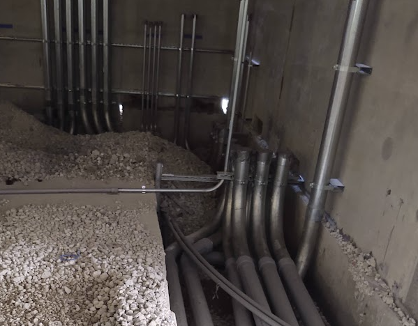 NEC 300.5 underground burial depths—conduit installation at foundation wall