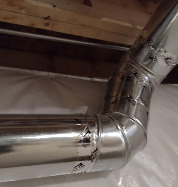 Rigid galvanized steel dryer duct with multiple smooth-radius elbows, mechanically fastened and sealed with foil tape to meet 2021 IRC code requirements.