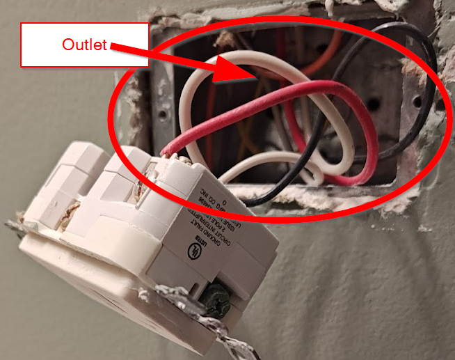 Open electrical outlet box with labeled outlet, showing typical branch circuit wiring requiring AFCI protection under NEC 210.12.