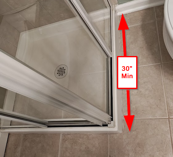 Shower entry showing 30 inch minimum length for IRC bathroom code compliance