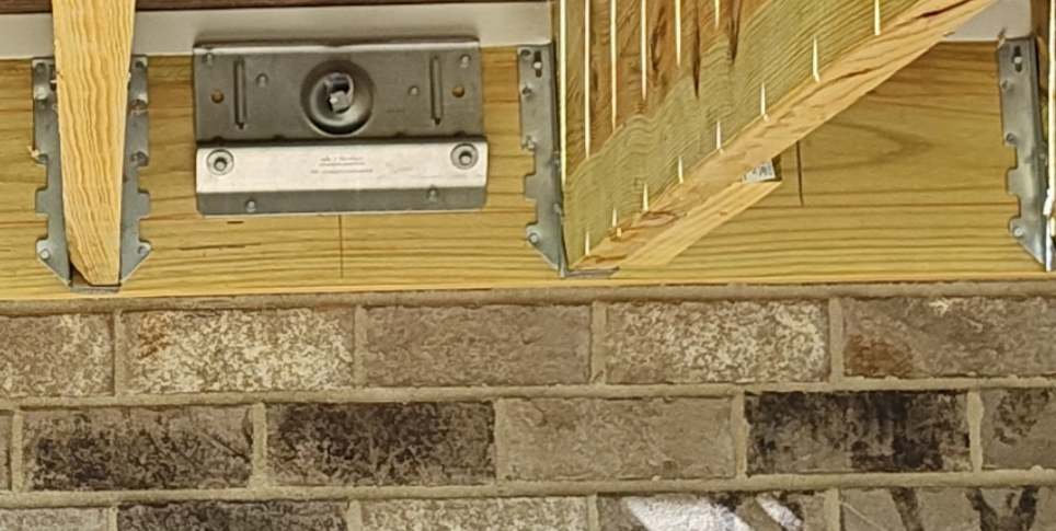 proprietary brick veneer ledger connector transferring deck load to rim joist framing