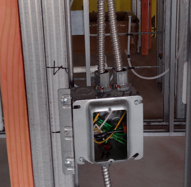 Type MC cable installation showing insulated equipment grounding conductors in metal-framed commercial construction