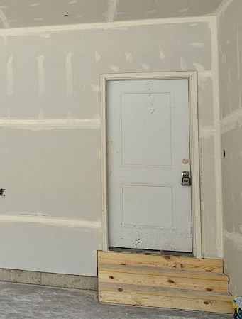 Garage stairs landing requirement under IRC R311.7.6 showing enclosed garage stairs without a separate top landing