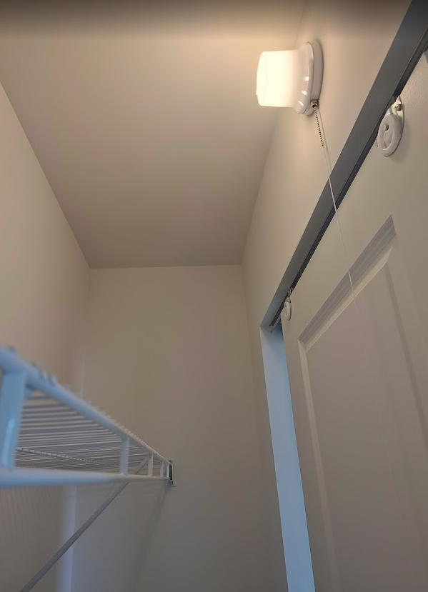 Code-compliant surface-mounted LED closet light installed in a clothes closet in accordance with NEC 410.16 closet lighting code requirements.