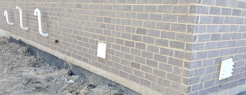 Furnace vent clearance from air intake on exterior wall