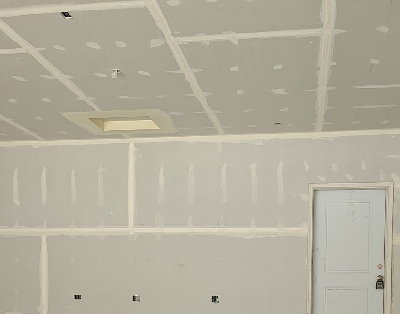 Garage electrical rough-in showing vehicle-bay receptacles and garage door opener receptacle opening